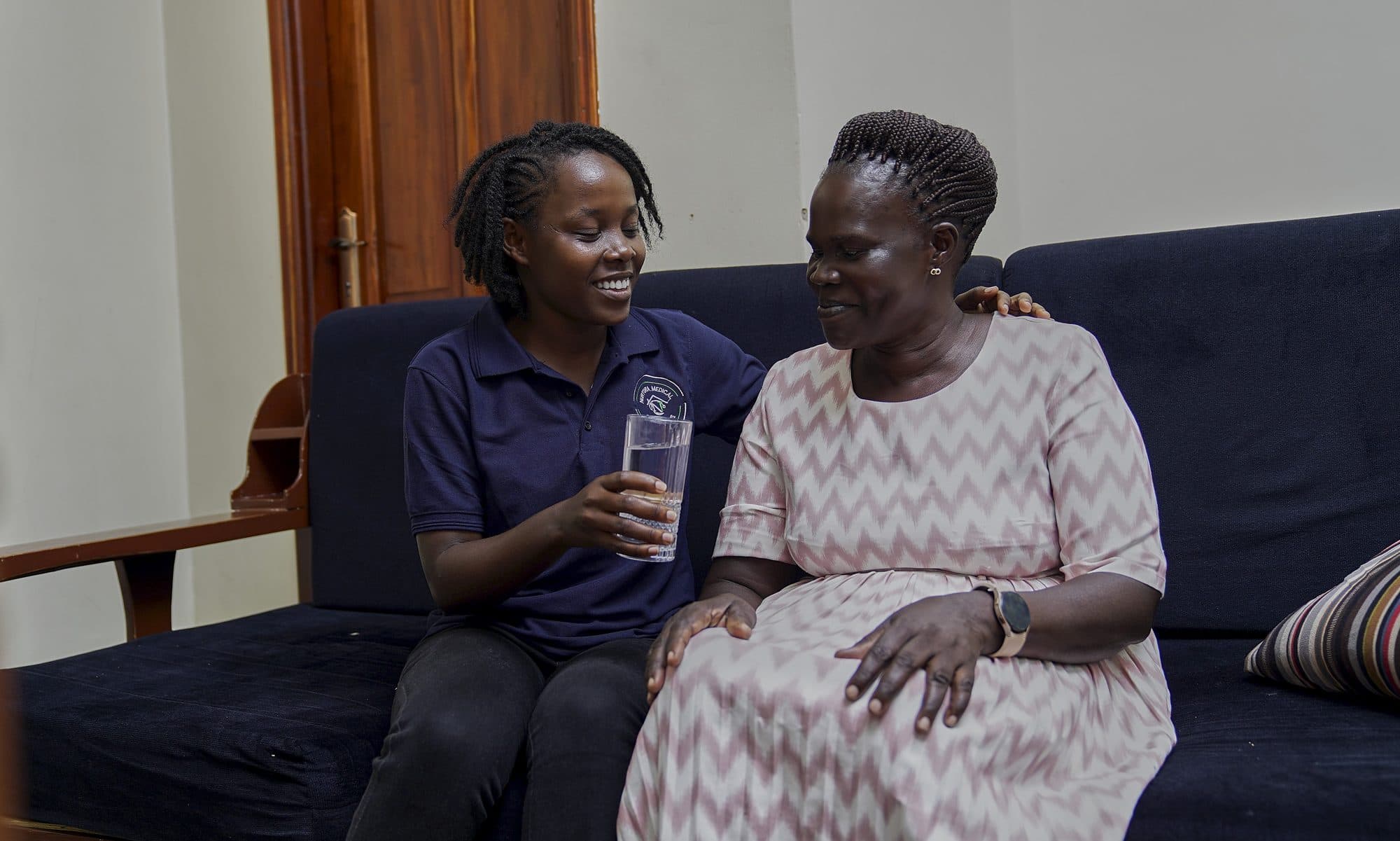 A visitor comforting a patient in hospital